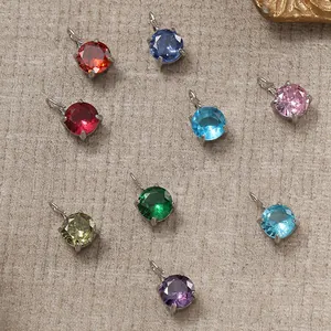 Detail of round cut multi-colored gemstone pendants with 14K gold-plated prong settings
