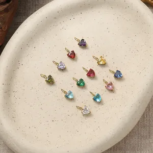 Detail view of heart-shaped colorful birthstone charms with golden metal bases