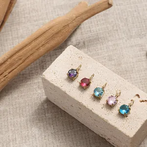 Macro shot of 14K gold-plated round zircon pendants for DIY necklace jewelry making