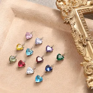 Macro detail of 12 colorful heart-shaped zircon charms with silver plating and metal loops