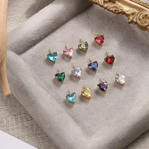 Detailed view of twelve colorful heart-shaped crystal pendants in gold settings