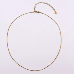 Macro detail of golden snake bone chain necklace with lobster clasp and extension