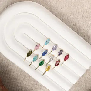 Detail of twelve colorful marquise cut gemstones in gold plating for DIY jewelry