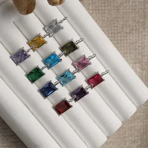 Macro shot of colorful rectangular cubic zirconia pendants with gold-plated metal settings