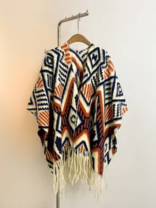 Detailed view of the ethnic geometric patterns and thick knitted texture with fringe tassels