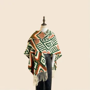 Detail of knit shawl featuring geometric jacquard patterns and elegant long tassels