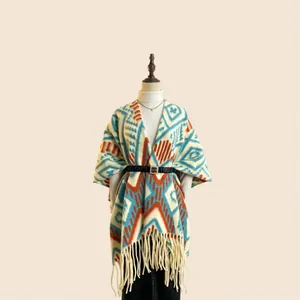 Detailed view of thick tribal geometric shawl with tassels and a metal buckle belt