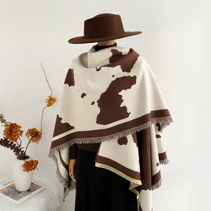 Women's brown cow print travel shawl cape with fringe and warm knit texture