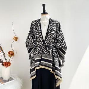 Detail of leopard print shawl with fringe hem and a black waist belt for styling