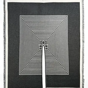 Detailed view of black geometric cashmere wrap with white nested lines and soft fringe edge