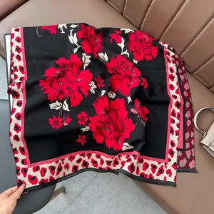 Detailed macro shot of vintage jacquard scarf with red floral pattern and leopard trim