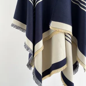 Detail showing high-quality navy and cream striped cashmere shawl with fringe accents