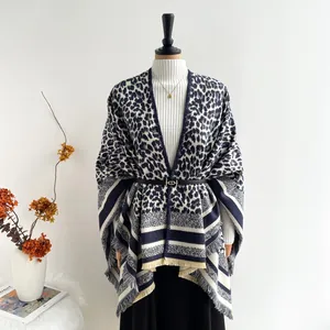 Detailed view of elegant navy and beige leopard print shawl with fringe and waist belt