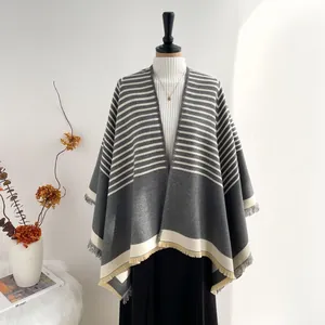 Detail view of striped imitation cashmere shawl with elegant fringe and color block design