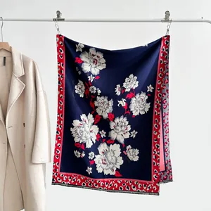 Detail of vintage floral jacquard scarf with red leopard print border and soft tassels