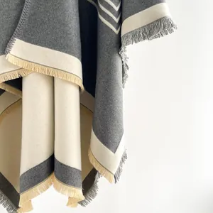 Macro view of geometric cashmere-style shawl texture with detailed tassel fringe