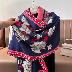 Detailed close-up of navy jacquard floral scarf with leopard print edge and soft texture