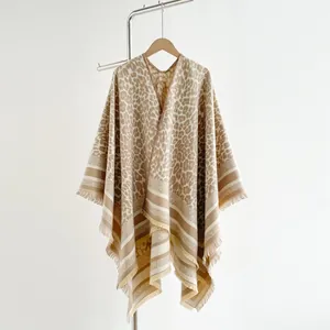 Detail of leopard print shawl cape with V-neck opening and fringed tassel hem edges