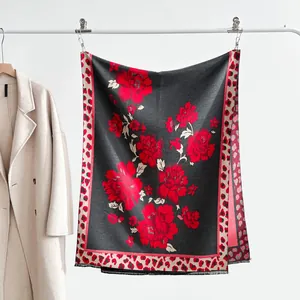 Close-up of vintage floral jacquard scarf with red leopard print borders and tassels