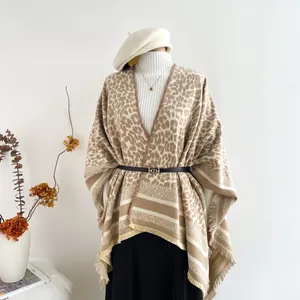 Close-up of leopard print shawl with tassels and belt detail on a mannequin display