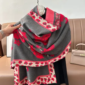 Detailed close-up of vintage floral jacquard shawl with red flowers and leopard print