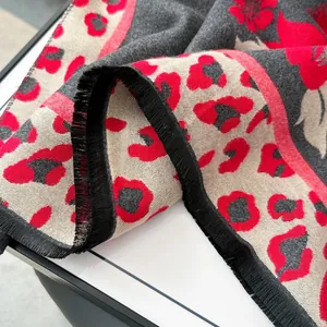 Close-up of vintage floral leopard jacquard scarf with fine black fringe tassels