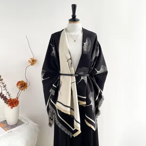 Elegant knit ginkgo leaf shawl with fringe detail in black and white tones