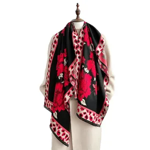 Vintage floral and leopard print thick warm scarf shawl on a beige coat mannequin
