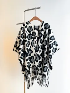 Detail of leopard print shawl with long tassels and thick knit cashmere texture