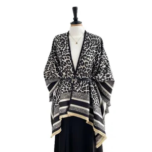 Elegant leopard print split shawl cape with fringe detail and monochrome stripe hem