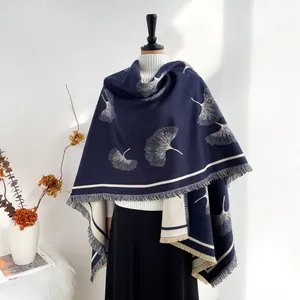 Detailed view of dark blue ginkgo leaf cashmere shawl with fringes and double-sided color