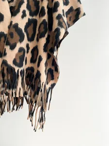 Detail of leopard print shawl showing thick cashmere-like texture and fringed edges