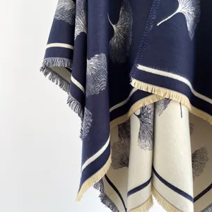 Detail of soft ginkgo leaf pattern knit shawl with elegant fringed edges and texture