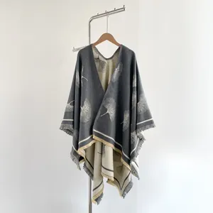 Close-up of fringe hem and ginkgo leaf jacquard on reversible cashmere-like shawl
