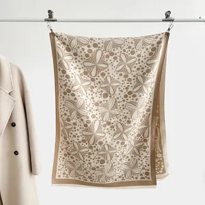 Detail of jacquard floral patterns and short tassels on a thick autumn shawl scarf