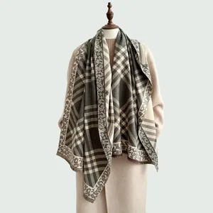 Detail of soft gray plaid and leopard print scarf with delicate fringe tassels