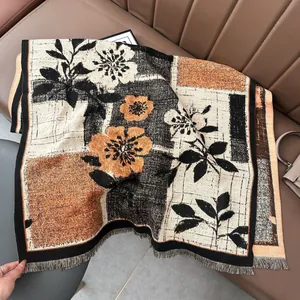 Detail of floral cashmere-like scarf with autumn color blocking and soft fringe edges