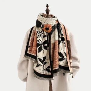 Vintage color-block floral cashmere shawl with tassels over a beige wool coat