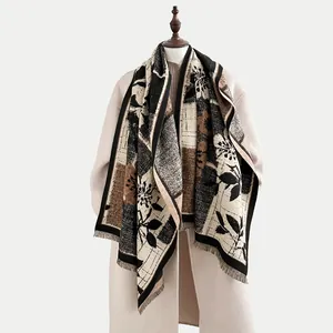 Close-up of vintage floral cashmere-feel scarf with tassels and geometric color blocks