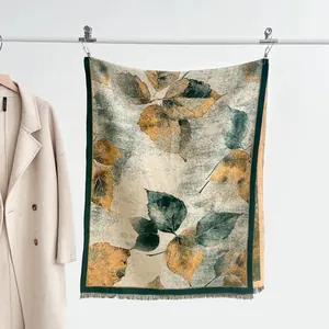 Detail of vintage leaf pattern cashmere scarf with fine tassels and premium woven texture