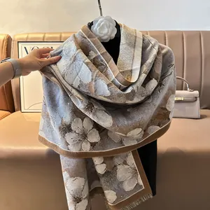 Detail of floral oil painting style scarf with fringed edges and soft woven texture