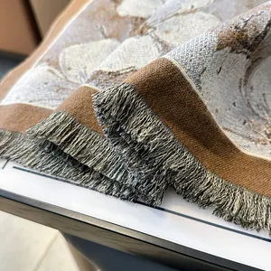 Close-up of thick floral oil painting scarf with jacquard leaves and fringe details