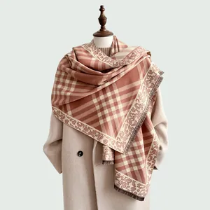 Detail of autumn plaid scarf featuring leopard print borders and soft brown tassels