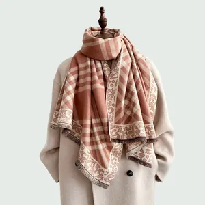 Detail of multi-patterned autumn scarf featuring plaid, leopard print, and fringed edges