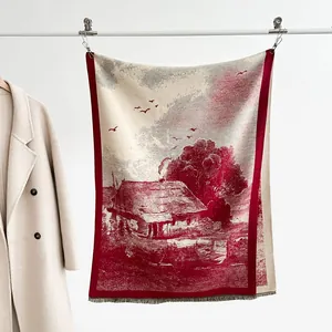Detail of red landscape print scarf with fringe edges and soft cashmere-like texture