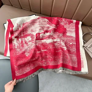 Close-up of red and white pashmina shawl with tassel fringe and landscape knit pattern