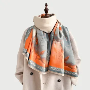 Close-up of winter floral scarf with orange and blue contrast and fringe details