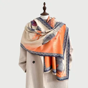 Detail of winter faux cashmere scarf showing artistic lotus prints and soft fringe tassels