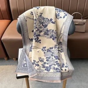 Detalle de bufanda de invierno con estampado de flores de ciruelo y bordes de flecos