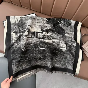 Detail of double-sided cashmere-like scarf showing vintage ink landscape and fringe